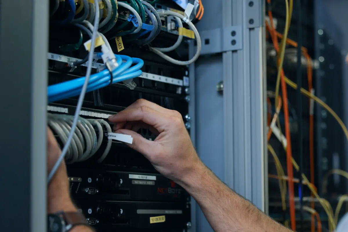 Technician working at server rack to keep high uptime